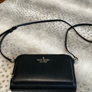 Cute black clutch with long strap, adjustable, removable . Very rigid.